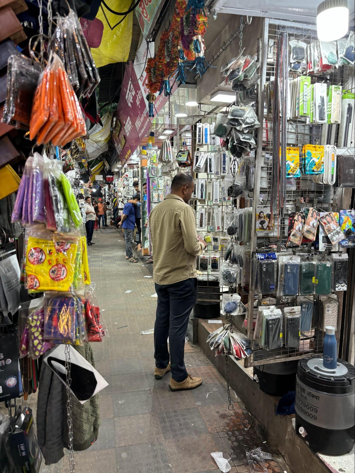 Shops in Hong Kong Lane, Pune, selling mobile accessories, textiles, and imported goods in a busy, narrow alleyway. (Source: CKA Archives)