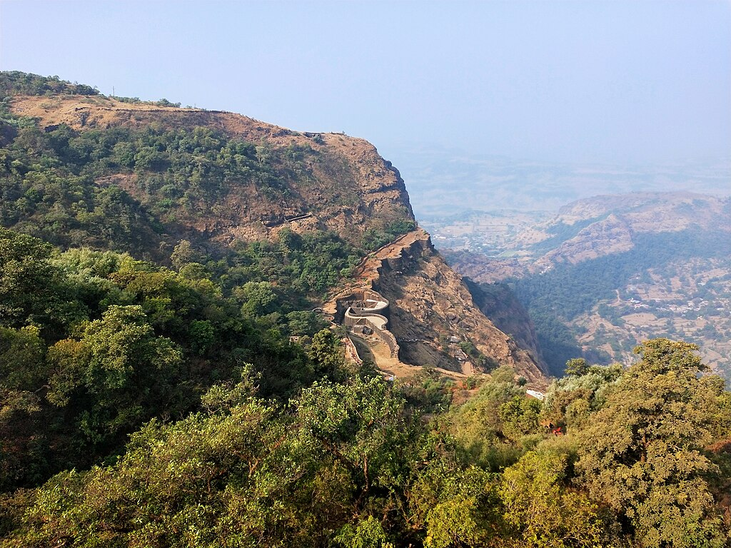 An overview of the Raigad fort complex perched atop the Sahyadri range, highlighting its elevated position and natural defenses.