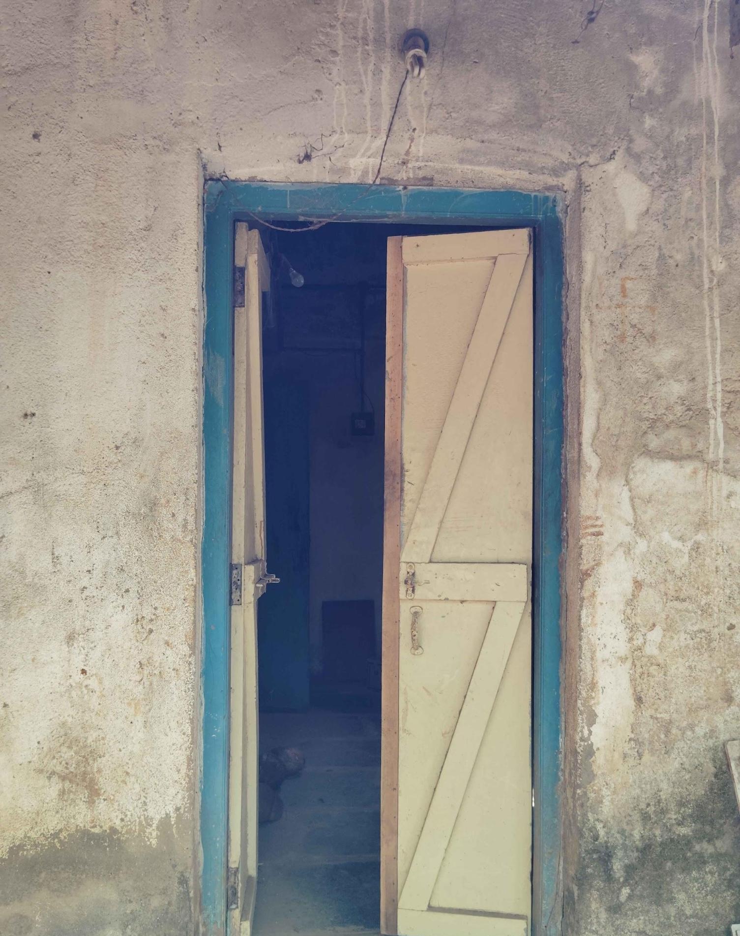 Main entrance door, a double-shuttered wooden door featuring zigzag patterns. (Source: CKA Archives)