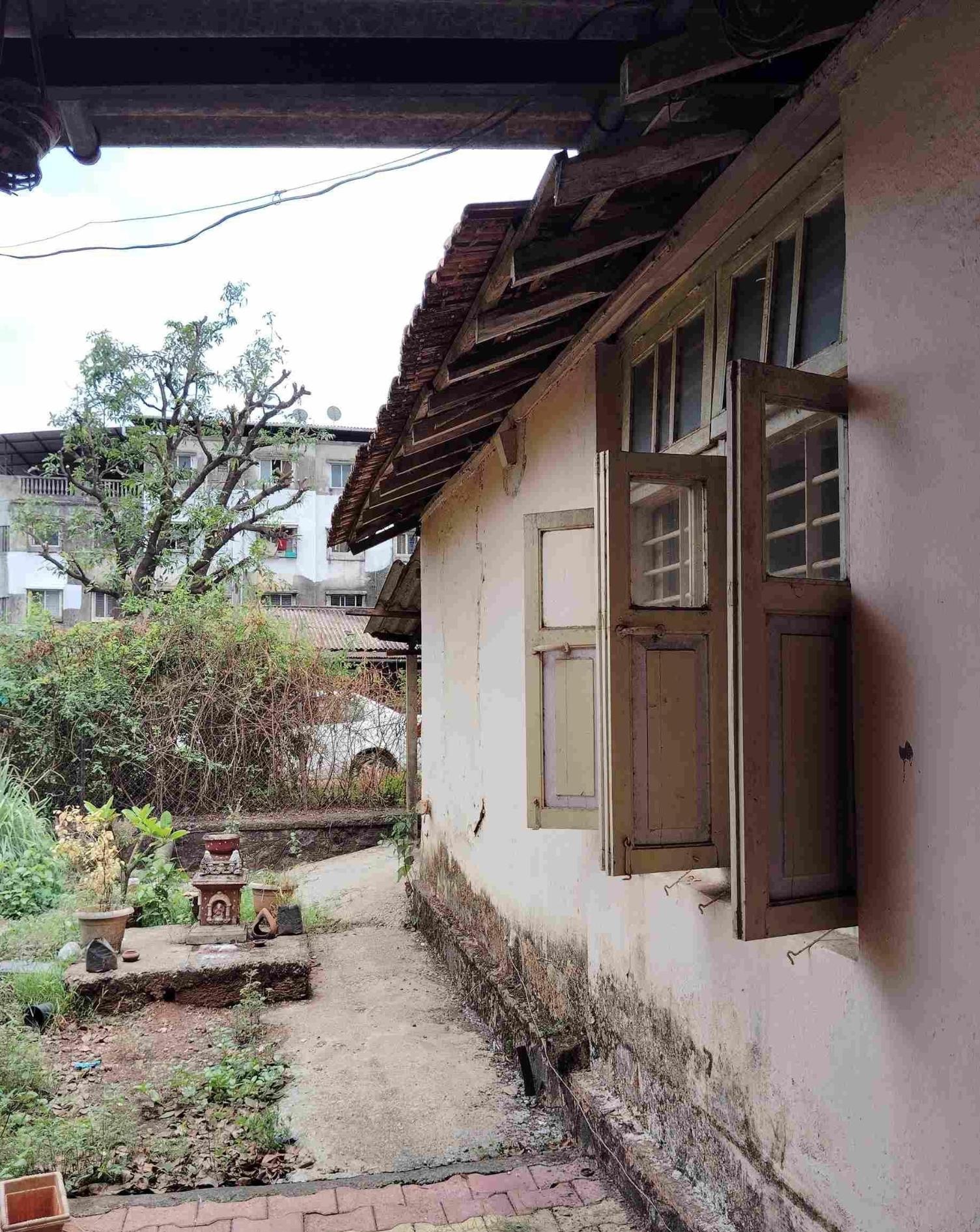 Neutral-colored wooden windows in the dining room with shutters that open outward. (Source: CKA Archives)