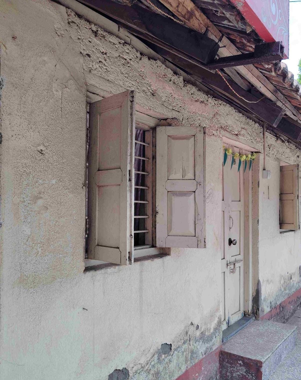 Window with wooden shutters and horizontal grills. (Source: CKA Archives)