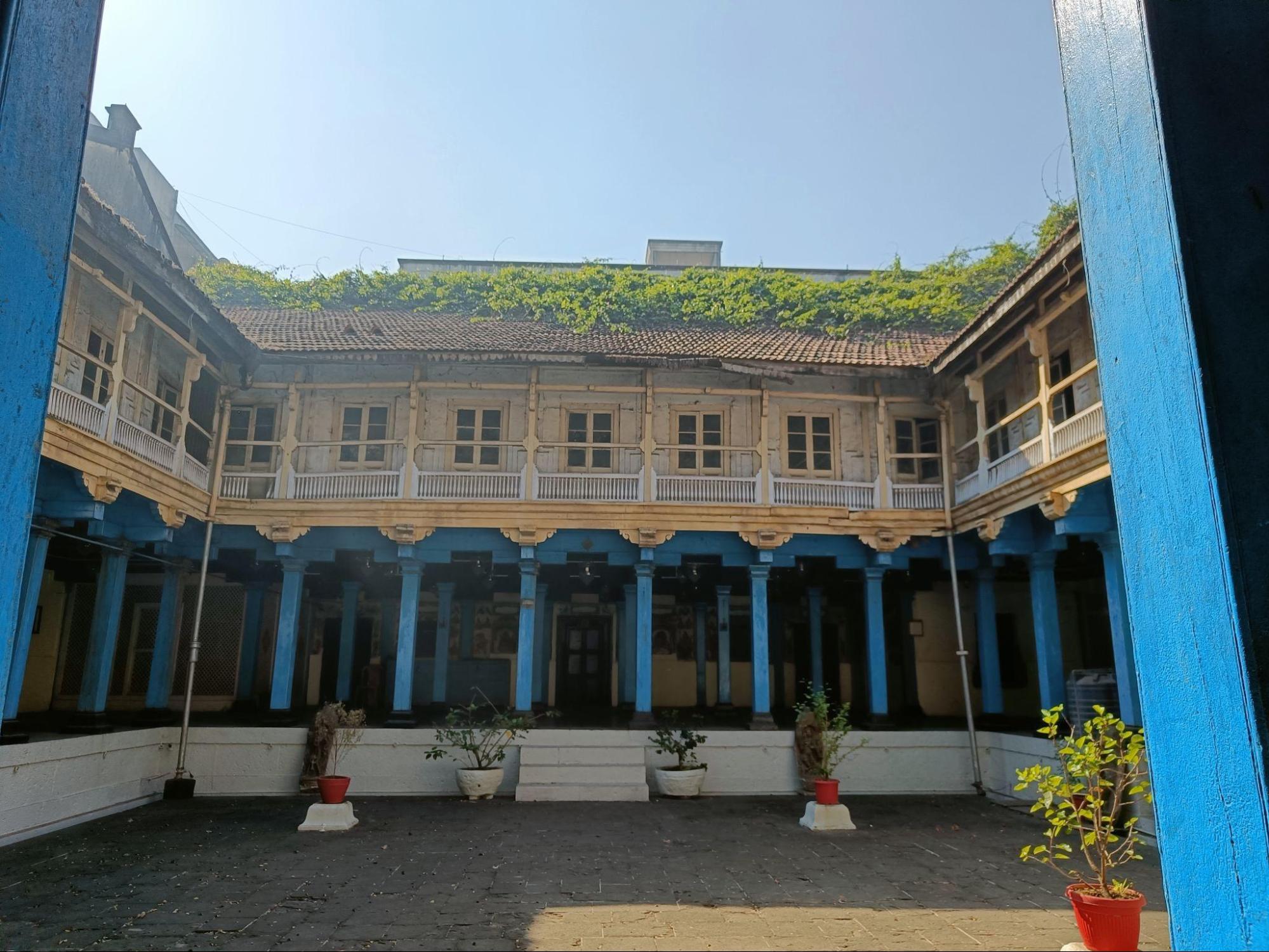 The central courtyard of Sangli’s Rajwada, showcasing its distinctive blue wooden pillars and the many rooms that lie within it. (Source: CKA Archives)