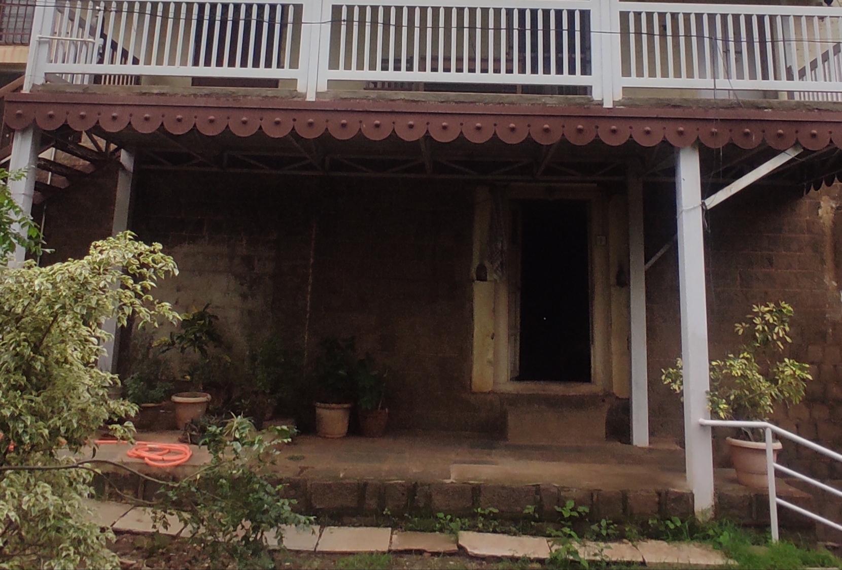 Cantilevered wooden balcony on the first floor. Timber brackets and simple railing elements support and frame the projection.(Source: CKA Archives)