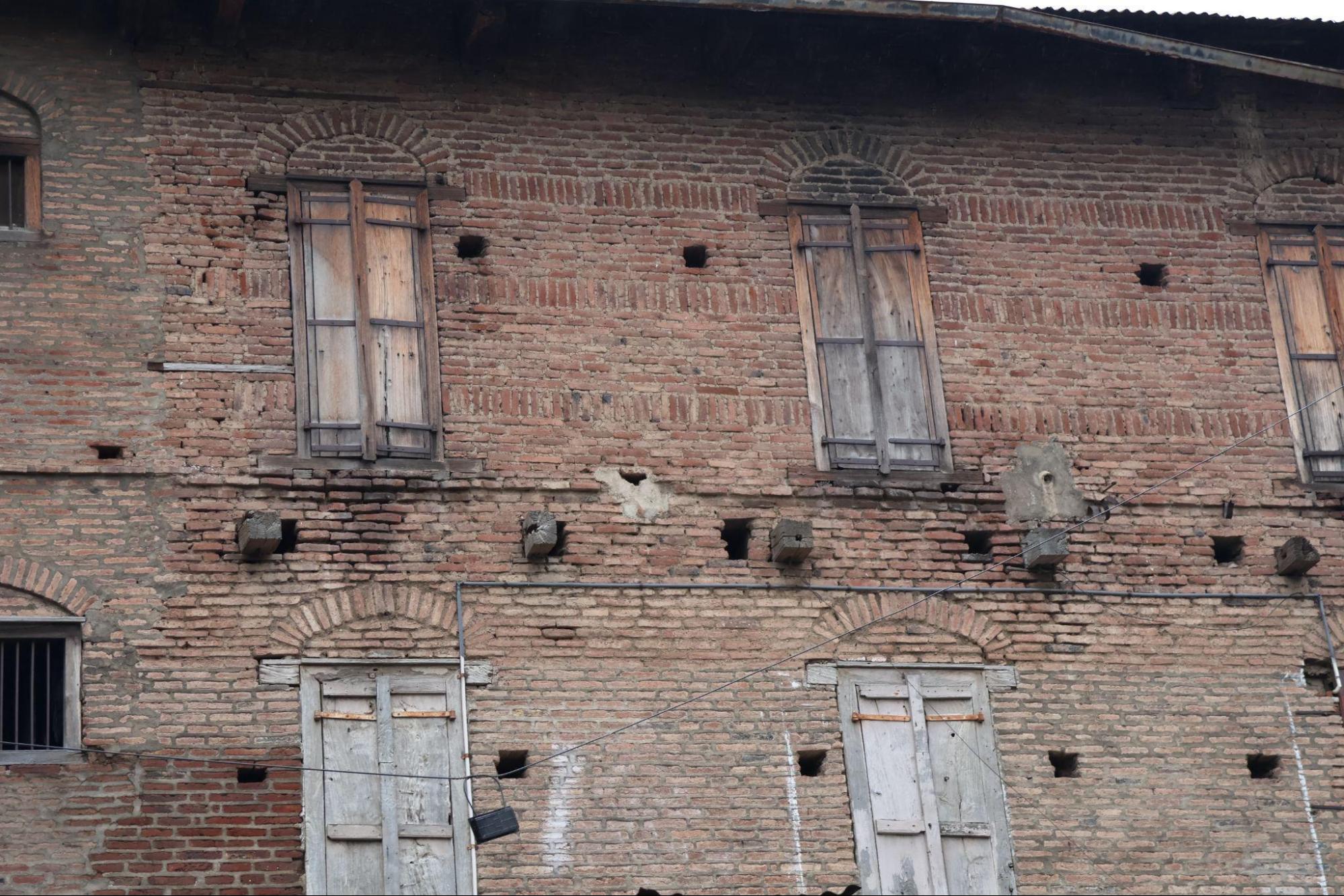 Front-facing windows with brick arches and timber panels. The symmetry and alignment define the elevation.(Source: CKA Archives)