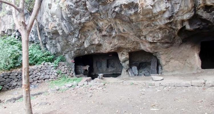 The entrance to Rajpuri Caves, Shindola, surrounded by sacred ponds believed to hold water from the Ganga.