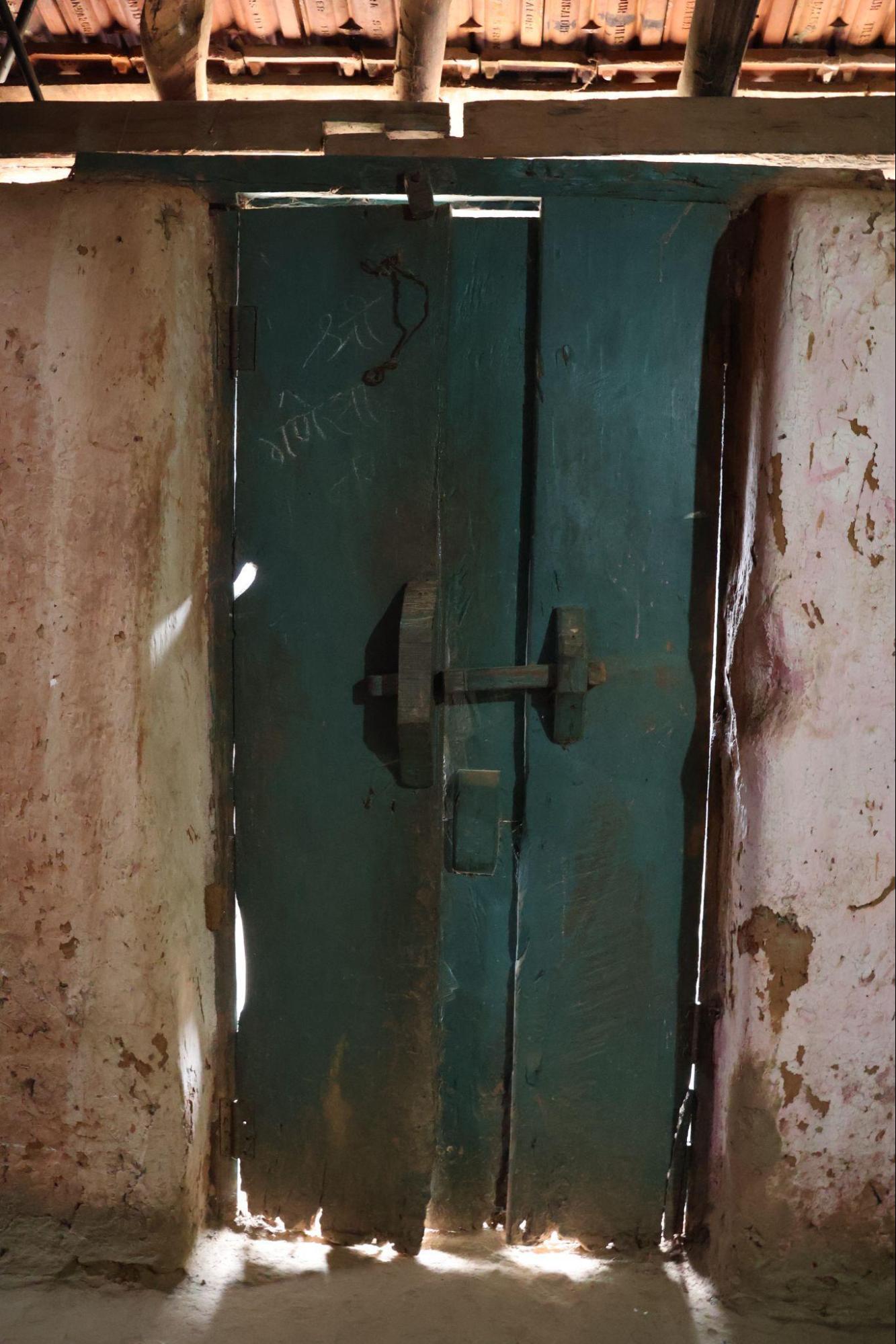 Double-leafed wooden door. A simple frame with recessed panels and a traditional locking system. (Source: CKA Archives)