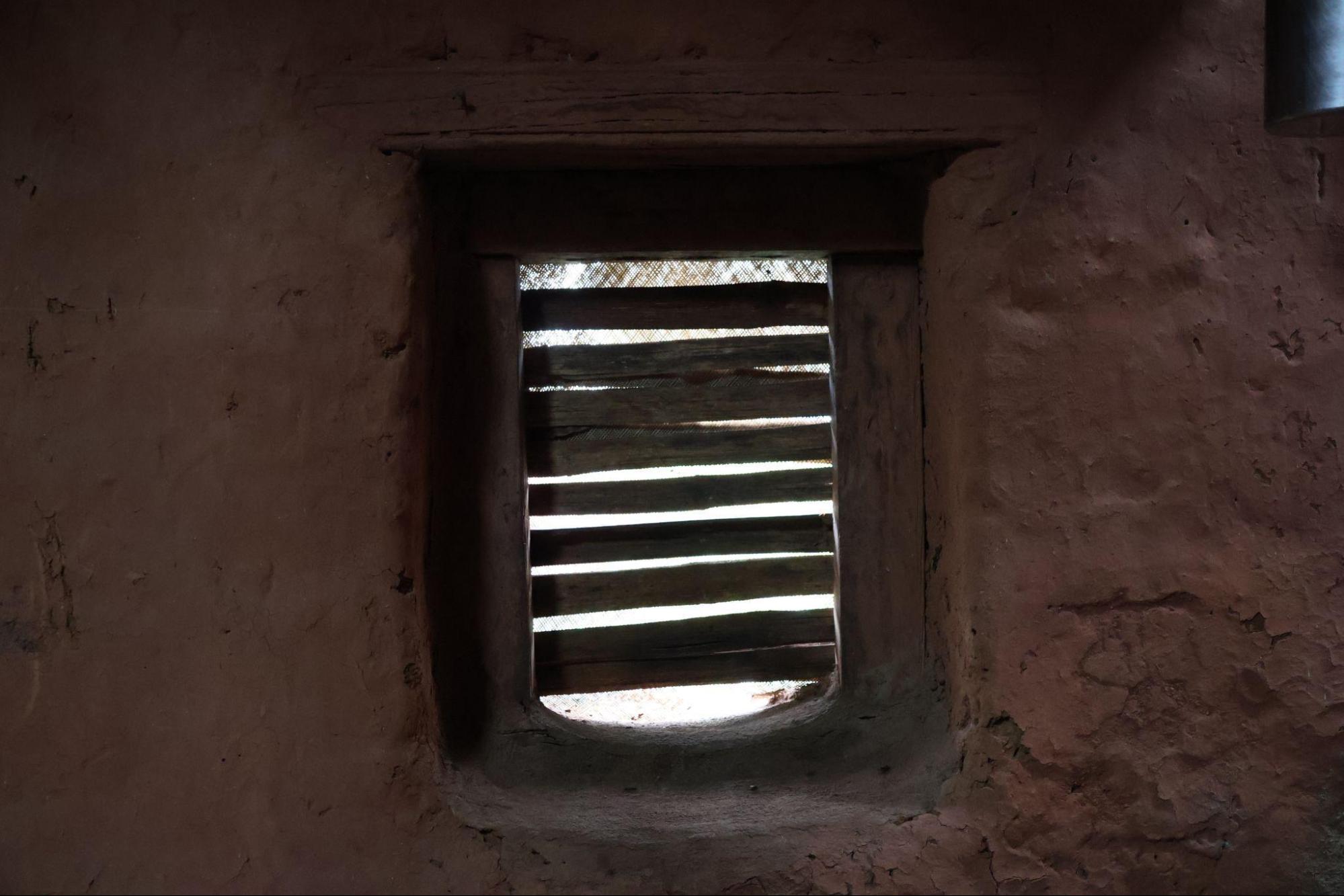 Small louvered window with wooden frame. The angled wooden slats allow ventilation while offering shade and privacy. (Source: CKA Archives)