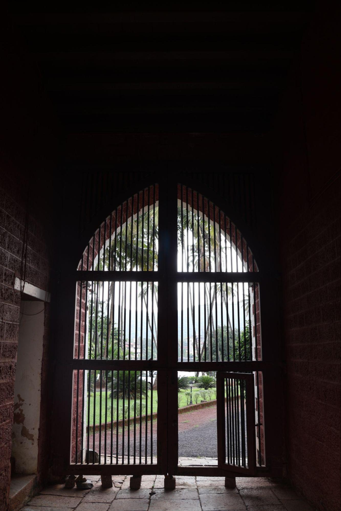 The main gate combines practical security with formal architectural detailing, including a smaller pedestrian panel within a larger arched frame. (Source: CKA Archives)
