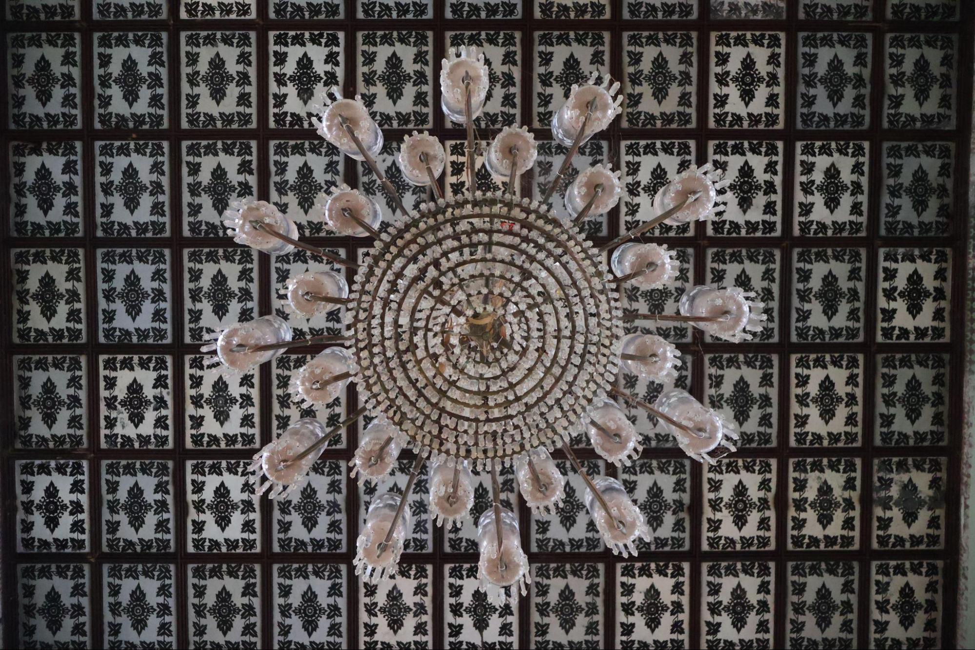 Zinc-plated ceiling of the Darbar Hall with intricate geometric motifs and a chandelier from the 1880s. (Source: CKA Archives)