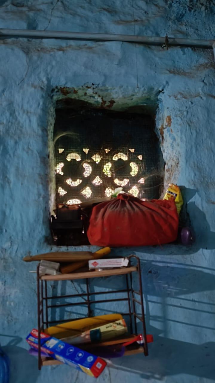 A window with intricate designs. Notice the wrapped red box. It is said that holy religious texts are tied in such red cloth and worshipped. (Source: CKA Archives)