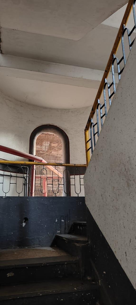 A closer view of the capsule-shaped window embedded in the lift core where one can see a curved motif, repeated across grills and other architectural features. (Source: CKA Archives)