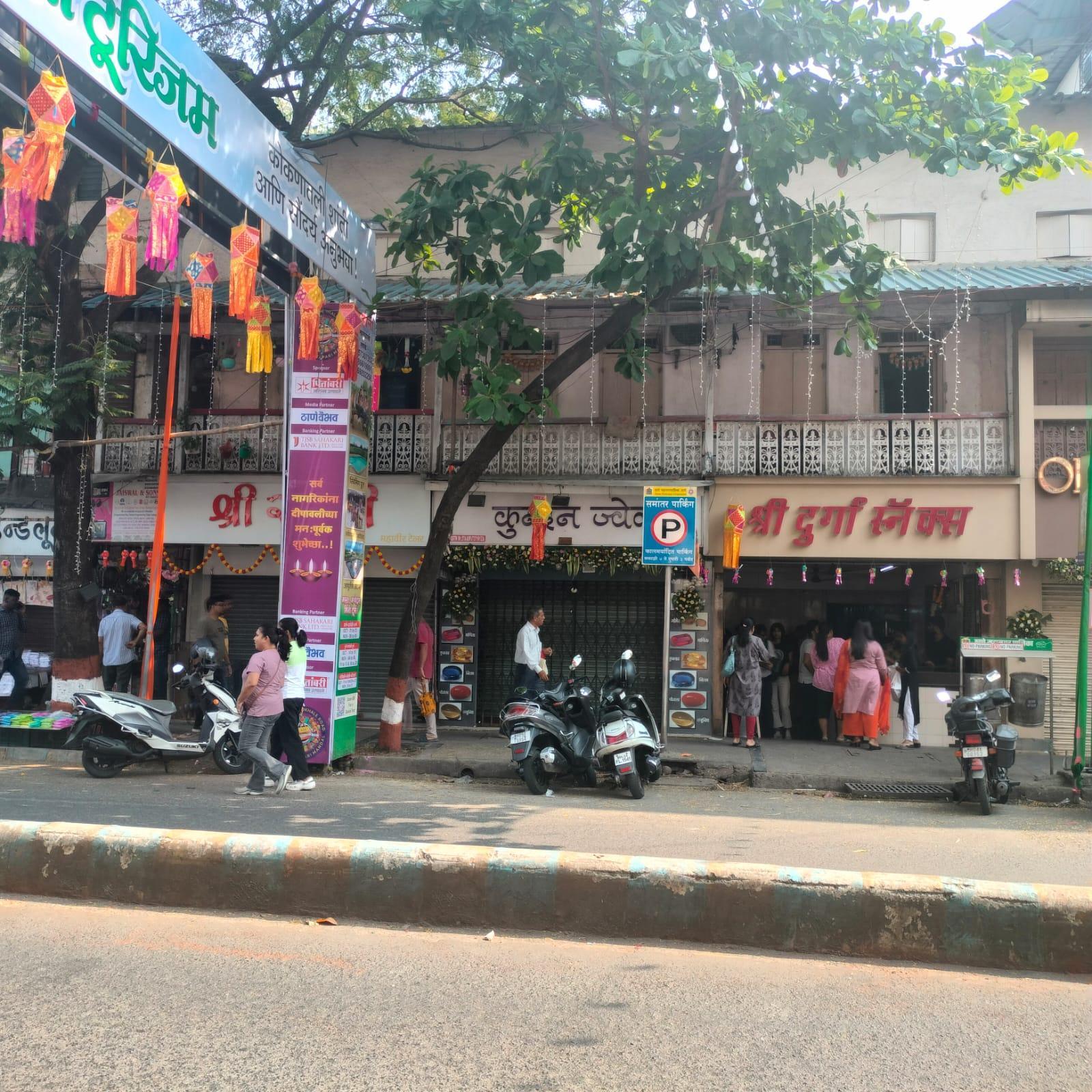 Front elevation of the Rajput Building showing ground-floor shops with a continuous balcony above, framed by cast iron railings. An interesting extended wall section above the balcony contains a row of clerestory vents just below the roofline. Notice how this element supports ventilation while also shaping the overall street-facing character of the building.(Source: CKA Archives)