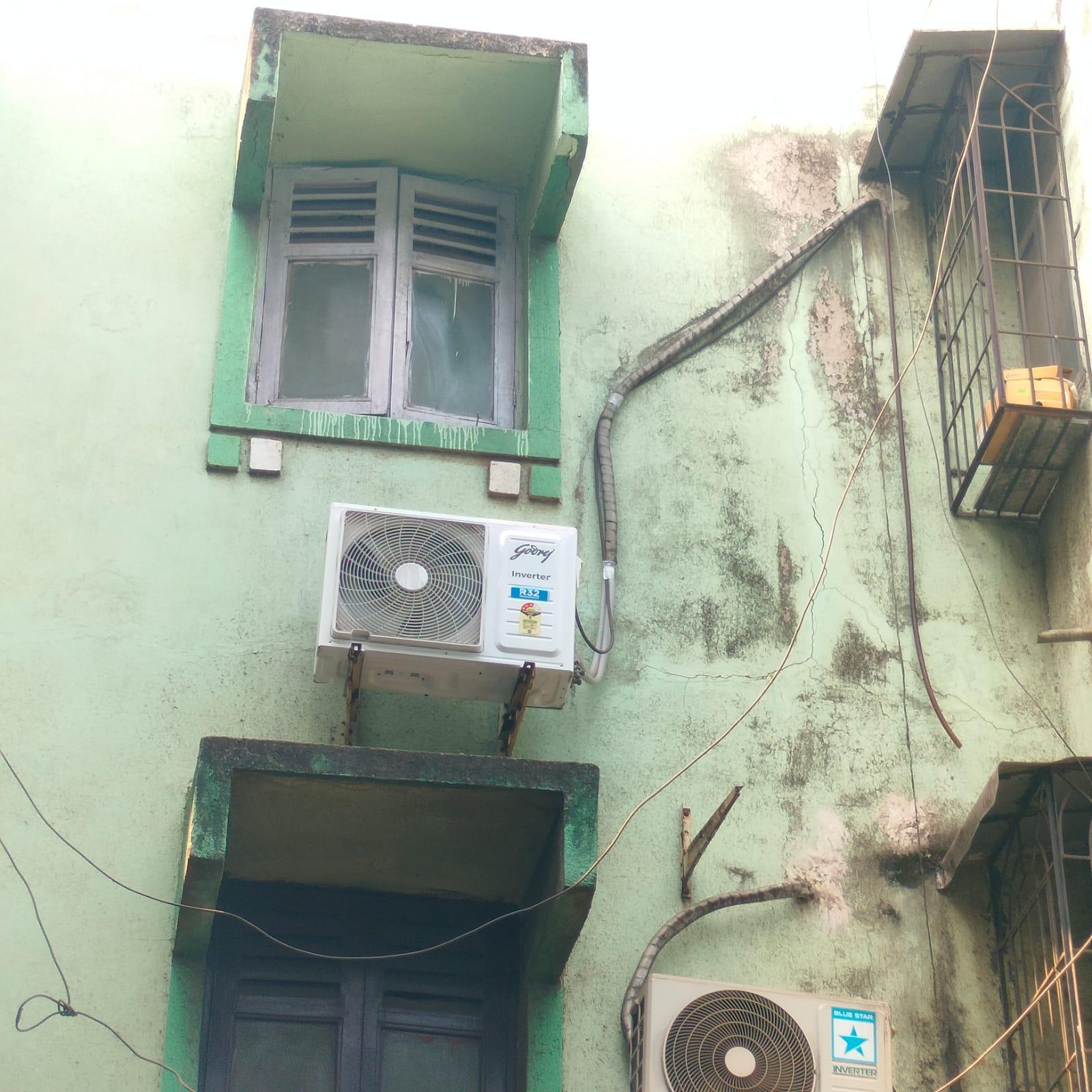 Old wooden windows with glass panels, which are double-doored and have vents are still visible, alongside later additions such as AC units and extended grills. (Source: CKA Archives)