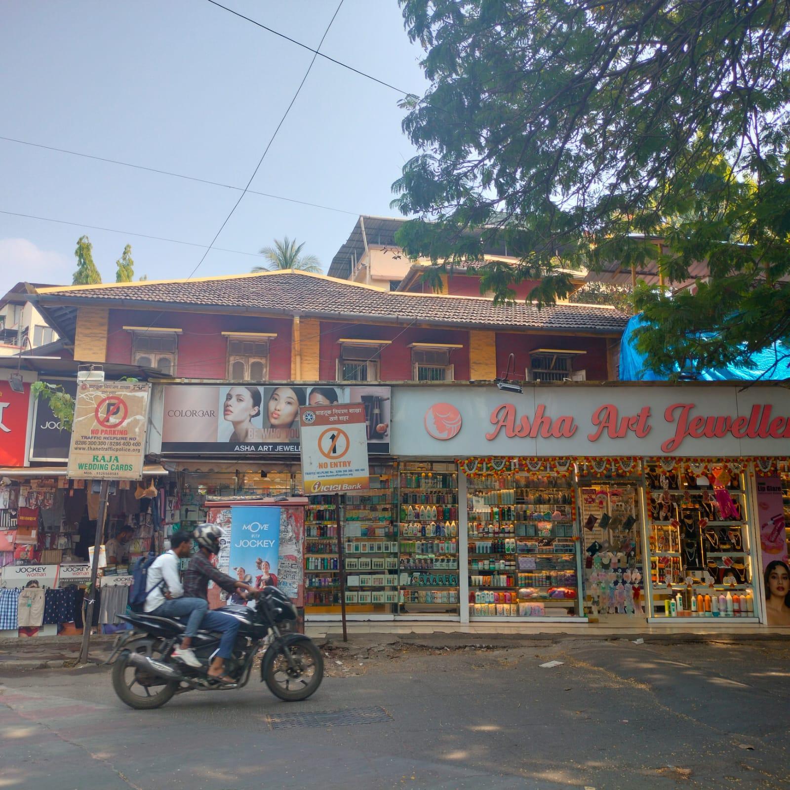 Thebuilding’sextended roofline creates a visible edge along the upper portion of the facade. The bold yellow finish further accentuates the form, contrasting with the muted tones of the newer commercial layer in front.(Source: CKA Archives)