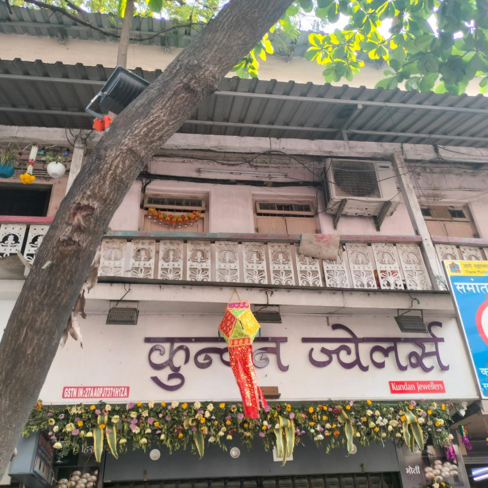 Timber doors with a raised panel design and integrated ventilation openings open onto the balcony. Positioned just beneath the sloped metal roof, the doors and overhang together support airflow and provide protection from sun and rain.(Source: CKA Archives)