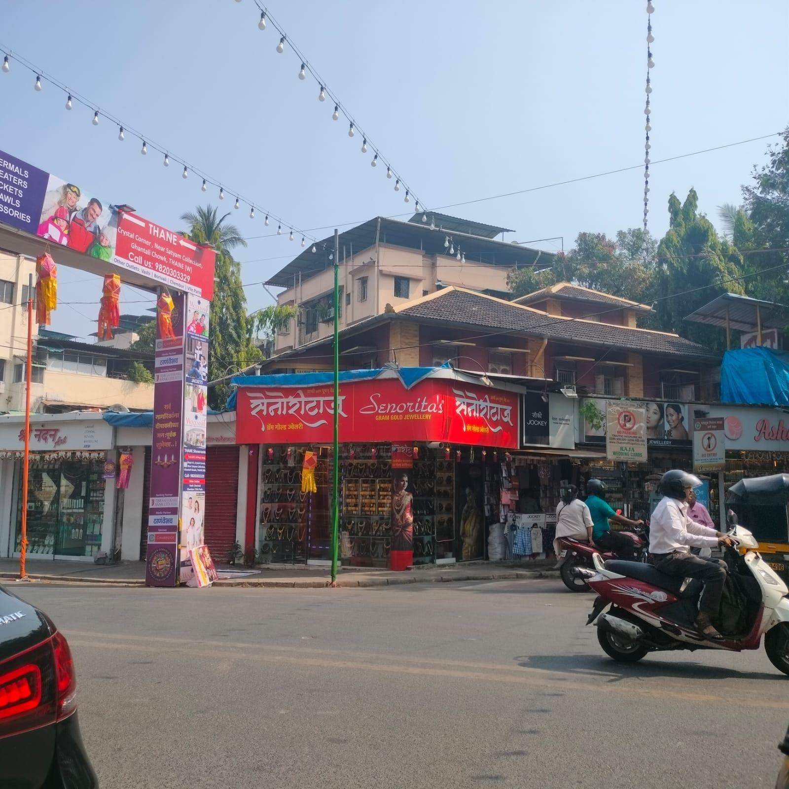 View of the old house at the junction of Gokhale Road and Vinayak Thakur Road. Painted in a bold yellow, the upper portion of the house stands out from behind the shops, hinting at its original character despite being partially concealed. (Source: CKA Archives)