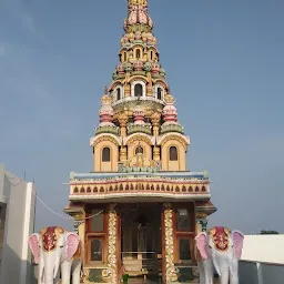 Colorful shikhara of Shri Ghanti Baba Mandir, Digras, with the tall spire rising above the compact shrine structure.[5]