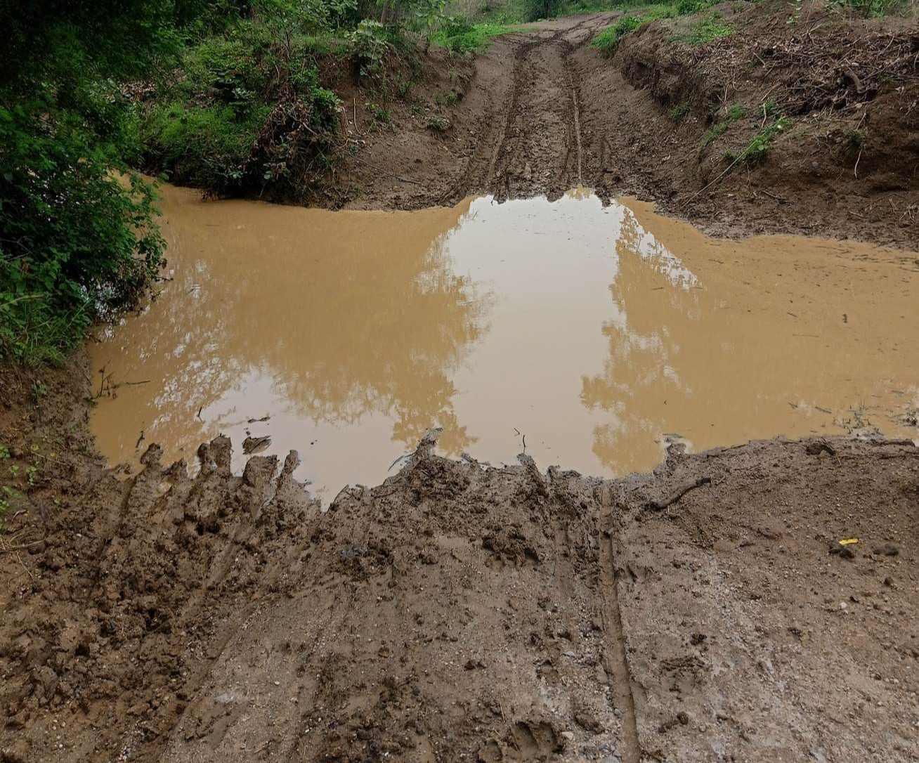A rural mud road flooded due to rain. (Source: CKA Archives)